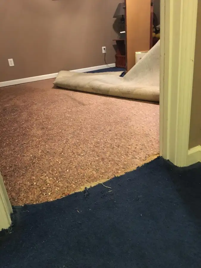 Carpet pad removal revealing water damage during Drying & Dehumidification in Fruitland